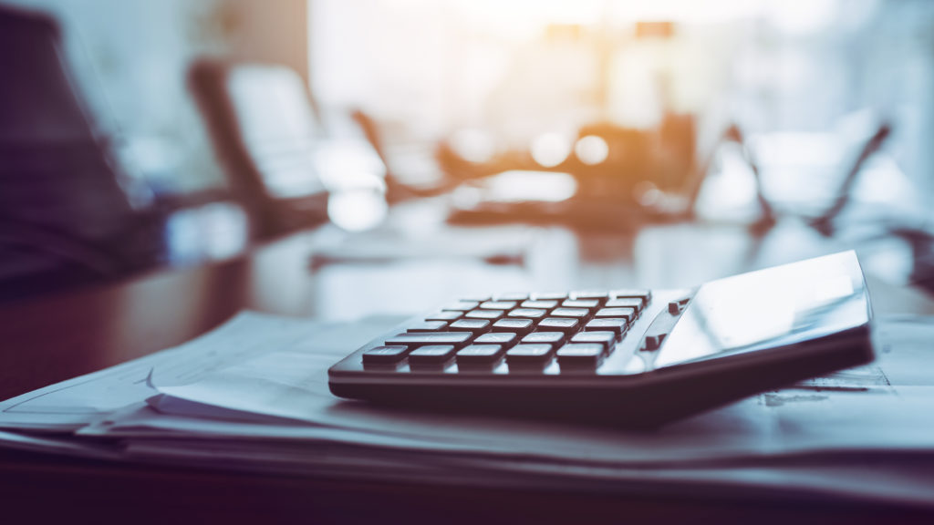 Close up calculator on business working desk symbolizing telecom tax fees